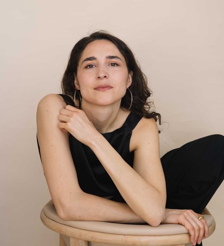 Alena Margarita Kroker seated in a black outfit